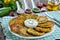 Delicious zucchini fritters on plate, close-up