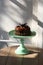 Deliciously divine chocolate cake with cream on pale green shabby chic table.