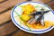 Deliciously fried sprats with scone and potato croquettes on plate