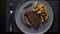 Deliciously grilled sirloin steak and crispy potatoes plated on a white dish with pork top view. Generative AI