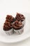 Deliciuos and pretty miniature cupcakes with chocolate topping