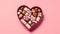 Delight your senses with heart shaped candies in a charming box on a pink background