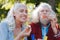 Delighted aged woman looking at the soap bubble