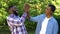 Delighted black men giving high five, happy brothers enjoying time together