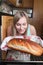 Delighted blond woman baking bread