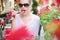 Delighted brunette lady eating sweet strawberry