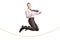 Delighted businessman jumping over a rope