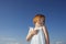 Delighted Cute Girl Looking Away Against Blue Sky