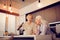 Delighted elderly women standing in the kitchen