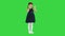 Delighted girl in black dress clapping her hands on a Green Screen, Chroma Key.