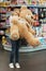 Delighted little girl holding big teddy bear