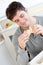 Delighted man eating bread in the kitchen