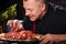 Delighted man eating crayfishes in restaurant