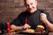 Delighted man preparing to eat burger and French fries