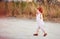 Delighted redhead toddler baby boy walking outdoors, at summer field