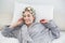 Delighted relaxed blonde woman in hair curlers making a phone call