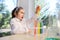 Delighted schoolgirl observes a chemical reaction going in a test tube with colorful reagents and chemicals