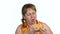 Delighted woman eating burger on white background.