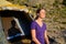 Delighted woman enjoying harmony in the mountains, sitting in the camp and closing her eyes