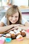 Delighted woman looking at cakes in the kitchen