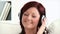 Delighted young woman listen to music wearing headphones