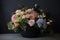 delightful arrangement of pastel blooms, arranged in chic black vase