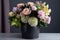 delightful arrangement of pastel blooms, arranged in chic black vase