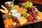 delightful fruit and cheese plate, with mix of sweet and savory flavors