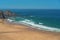 Delightful panoramic view of the Portuguese beach Odeceixe with tourists at the sea.