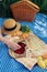 Delightful picnic spread: croissants, strawberries, lemonade on checkered blanket.