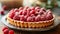 A delightful raspberry almond tart featuring sweet raspberries atop a frangipane filling.