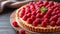 A delightful raspberry almond tart featuring sweet raspberries atop a frangipane filling.