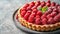 A delightful raspberry almond tart featuring sweet raspberries atop a frangipane filling.