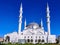 The delightful white Kocatepe Mosque in Ankara Turkey. Beautiful muslim temple with four minarets on a background of green lawn