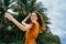 Delightful woman in a sundress has a rest on the nature on the island