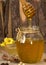 Delisious sweet honey flowing down in glass jar.