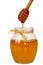 Delisious sweet honey flowing down in glass jar.