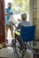 Delivering food to an elderly woman in a wheelchair