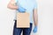 Delivery against Coronavirus 2019-nCov in pandemic Contactless delivery. Male hand in blue medical gloves holds craft paper bag on