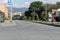 A Delivery boy riding bike in Lonely residential neighborhood main street during obligatory quarantine