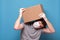 Delivery caucasian man carrying a heavy parcel box