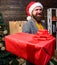 Delivery christmas present. Delivery service. Christmas is coming. Santa courier. Gifts delivery. Man santa hat deliver