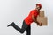 Delivery Concept - Handsome African American delivery man rush running for delivering a package for customer. Isolated