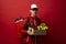 Delivery Concept - Handsome delivery man in a red uniform with thermal backpack carrying paper package bag of grocery