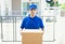 Delivery concept - Portrait delivery person in blue uniform hold