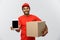 Delivery Concept - Portrait of Handsome African American delivery man or courier with box showing tablet on you to check