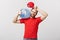 Delivery Concept: Portrait of smiling bottled water delivery courier in red t-shirt and cap carrying tank of fresh drink