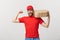 Delivery Concept - Portrait of Strong handsome delivery man flexing his muscle and holding pizza box packages. Isolated