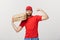 Delivery Concept - Portrait of Strong handsome delivery man flexing his muscle and holding pizza box packages. Isolated