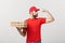 Delivery Concept - Portrait of Strong handsome delivery man flexing his muscle and holding pizza box packages. Isolated